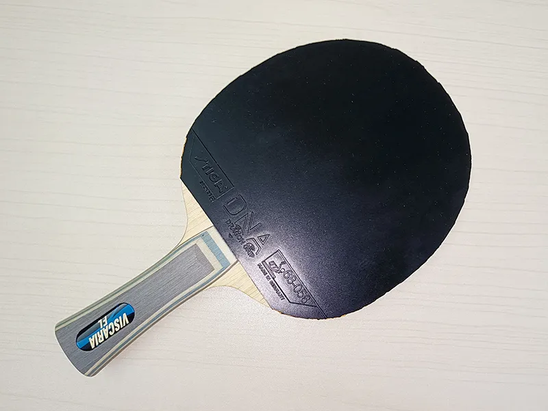 Stiga DNA Dragon Grip rubber underside showing blue sponge layer and branding